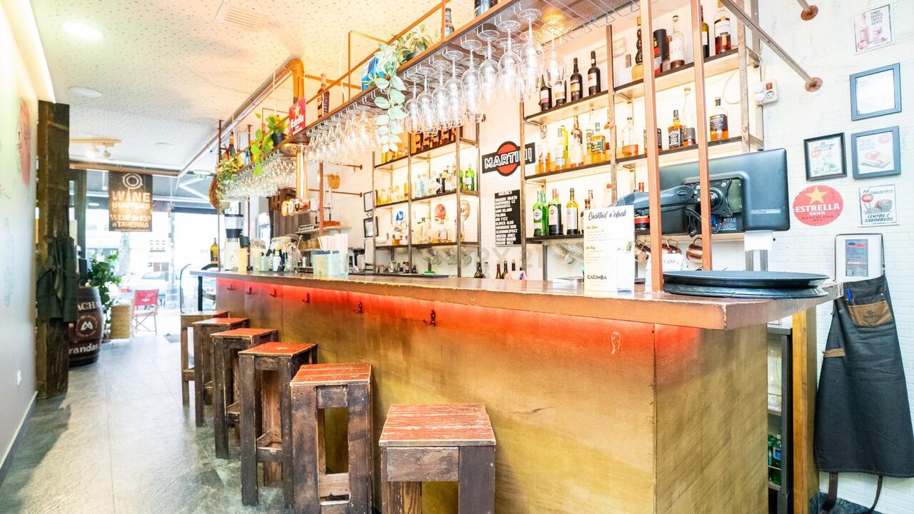 Bar counter with high stools and shelves of wine