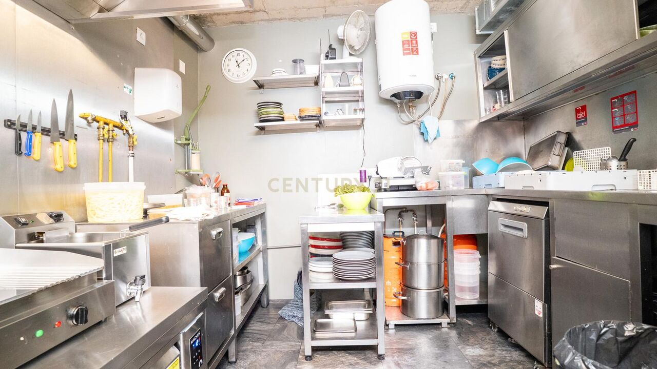 Stainless steel kitchen with prep counters and dishwasher